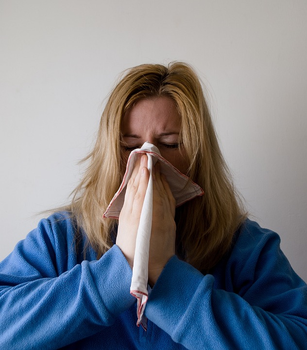 Woman blowing her nose