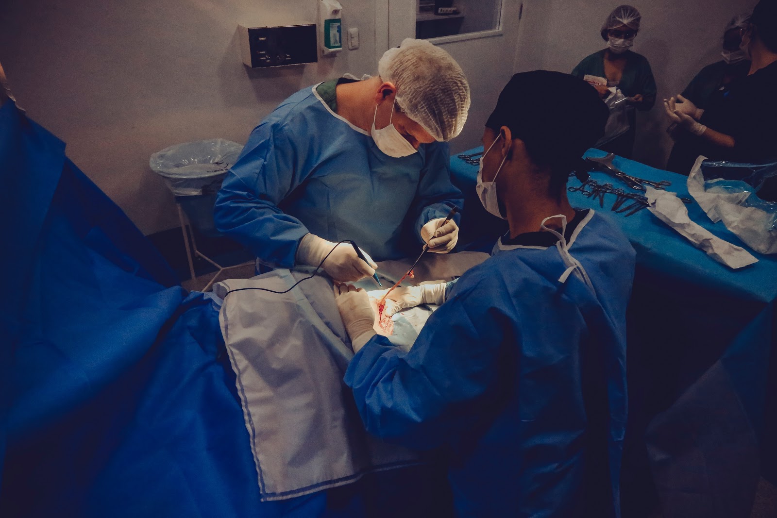 two surgeons in the operating room performing a surgery